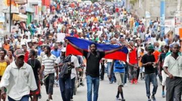 Haitian protester with the Haitian flag
