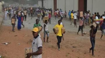 Residents looting a warehouse in Nigeria