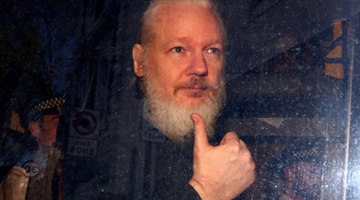 Julian Assange in a police vehicle
